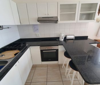 Under counter oven and glass top hob.